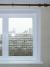 Фото 1. Фотография двухстворчатого пластикового окна TROCAL (профиль A3 Solid) с подоконником и откосами
